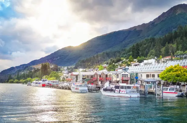 Stock photograph of Queenstown on the shores of lake Wakatipu, South Island, New Zealand during sunset.