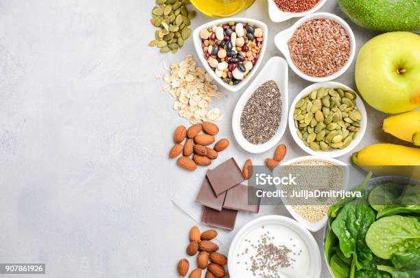 Healthy Food Nutrition Dieting Concept Banana Chocolate Spinach Avocado Apple Quinoa Chia Flax Seeds Yogurt Almond Beans Oat Pumpkin Seeds Olive Oil Stock Photo - Download Image Now