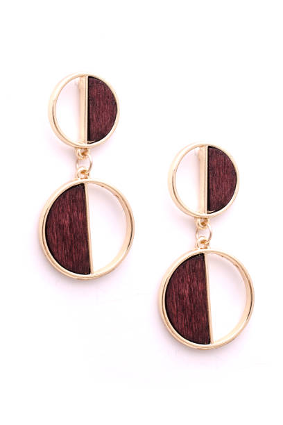 istock gold earrings with wooden insets, isolated on white 907862244