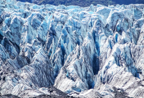 Fox Glacier in Westland Tai Poutini National Park in New Zealand Closeup stock photograph of the Fox Glacier located in the Westland Tai Poutini National Park on the South Island of New Zealand. fox glacier photos stock pictures, royalty-free photos & images