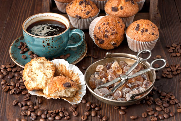 istock Coffee cup with  fresh muffins on wooden table 907865192