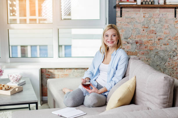 istock Optimistic woman relaxing with mug of beverage 907865214