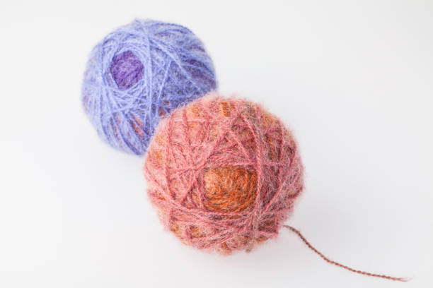 Yarn balls of different colors for knitting on a white background.