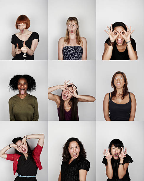 group of women pulling funny faces - cross eyed стоковые фото и изображения
