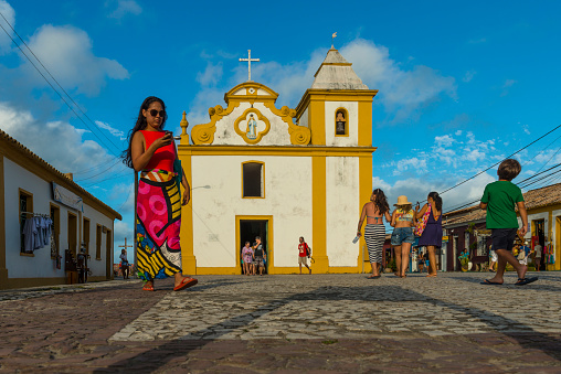 Porto Seguro, Bahia, Brazil - October, 20 2017: View of people at the square by the church 'Igreja de Nossa Senhora d'Ajuda', located at the district of Arraial d'Ajuda in Porto Seguro, Bahia state - Brazil