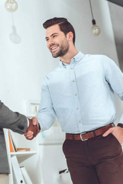 istock cropped image of african american and caucasian businessmen shaking hands 907867708