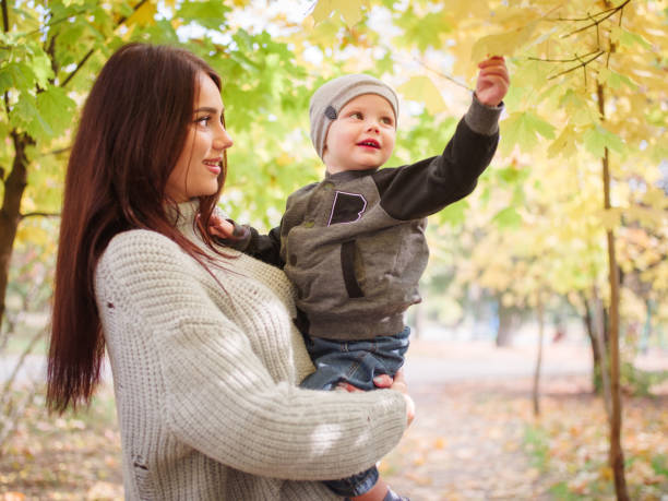 istock Mother and her child walkingin the park 907868564