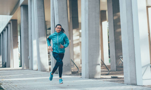 istock Woman jogging outdoors 907869008