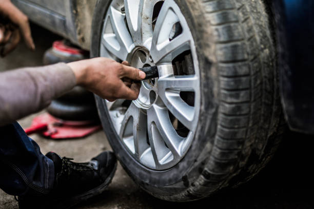 istock Mechanic changing a wheel on a car. 907869164