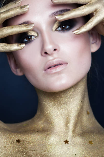 istock Elegant Woman. Creative Makeup with Gold Stars 907869268