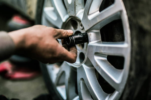 istock Mechanic changing a wheel on a car. 907869464