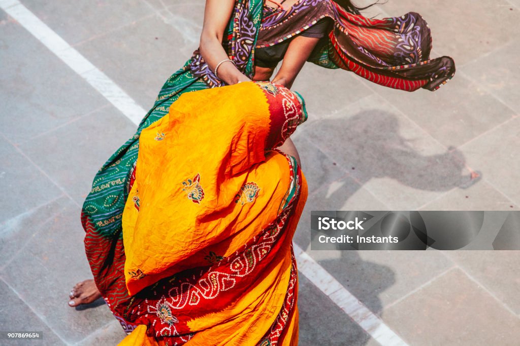 Two unrecognizable Indian women dancing together during Holi festival in Mathura district. Real people and travel photography. India Stock Photo