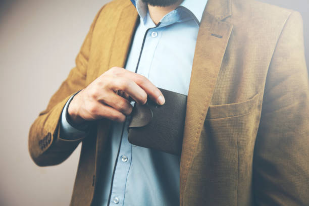 istock businessman putting wallet in his pocket 907869770