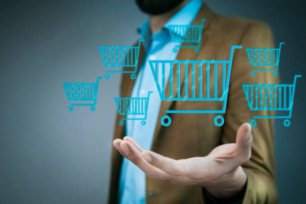 istock business man hand shopping basket on screen 907869828