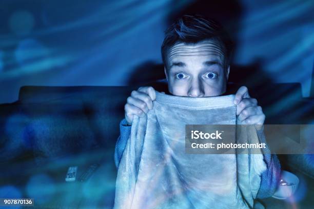 Man Is Afraid While Watching Tv Stock Photo - Download Image Now - Horror Movie, Watching, Men