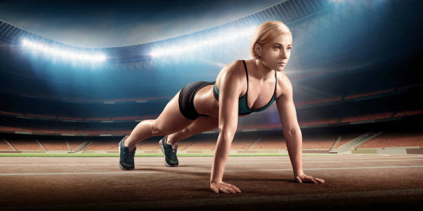 istock Sportswoman doing push ups on stadium 907872582