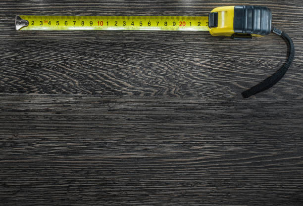 istock Tapeline on vintage wooden board top view 907872822