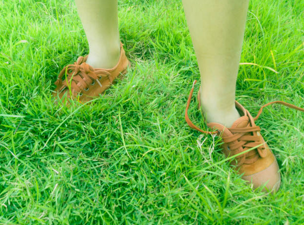 istock foot on green grass 907872860