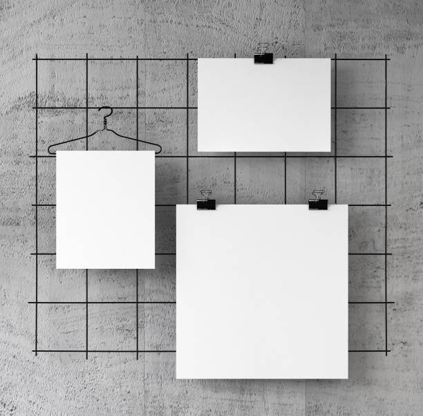 istock Posters on binder clips on Concrete wall. Paper mockups set. 907873372
