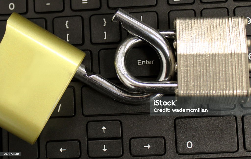 cyber security concept with open lock on keyboard opened locks on keyboard with word enter in center focus concept image of cyber security and hacking or virus Computer Stock Photo