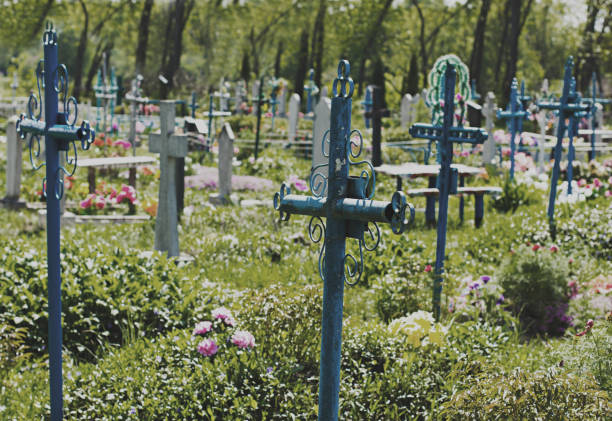 istock old cemetery overgrown with grass 907873850