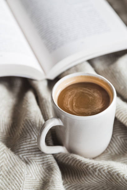 istock Cozy cup of hot chocolate with book 907877656