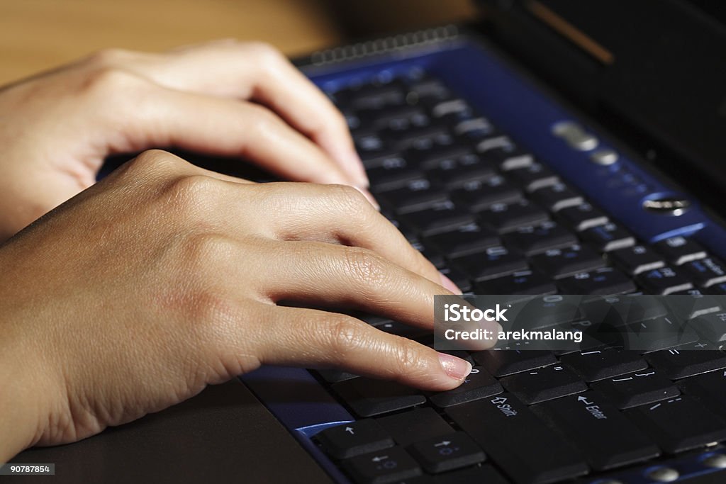 Businesswoman A businesswoman working and typing on her laptop Adult Stock Photo