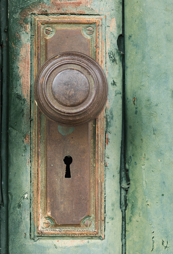 Detail photograph of an old, rusty doorknob. Photographed in Cooke City, Montana.