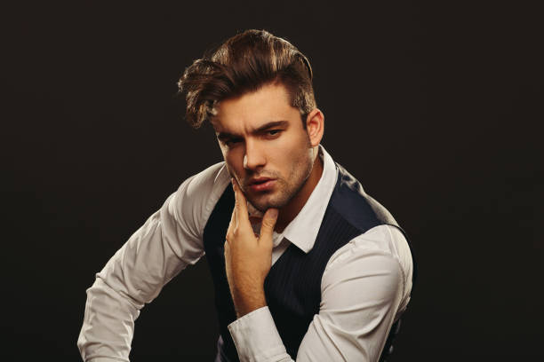 istock Portrait od handsome man in studio on dark background 907879340