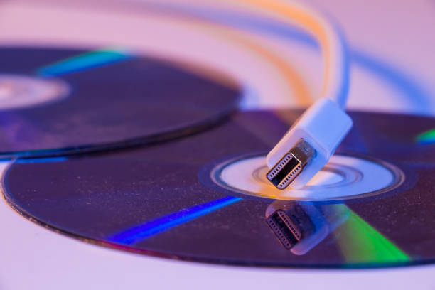 istock Closeup of white Mini Displayport cable with it's reflection on blank disc 907879540