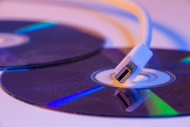 istock Closeup of white Mini Displayport cable with it's reflection on blank disc 907879856