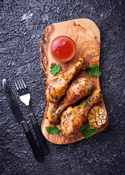 istock Grilled chicken legs with spices and garlic. 907882842