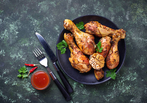istock Grilled chicken legs with spices and garlic. 907883218