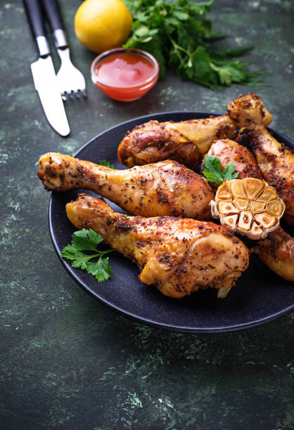 istock Grilled chicken legs with spices and garlic. 907883322