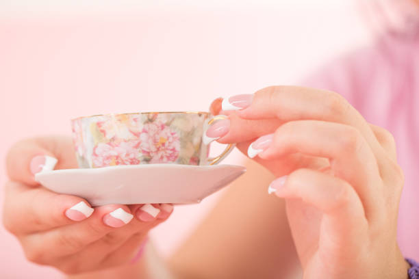 istock Hands With Polished Nails Holding a Coffee Cup 907885244