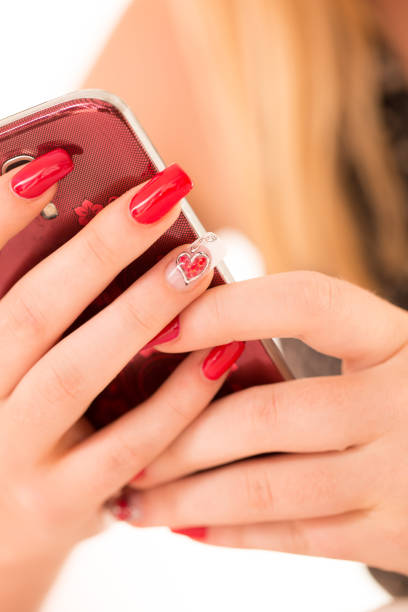 istock Woman With Polished Fingernails Using Mobile Phone 907885322