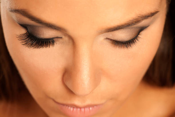 istock female eye with and without lash extension 907889180