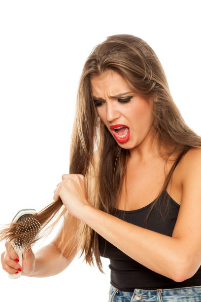 istock young beautiful nervous woman has a problem with combing 907889256