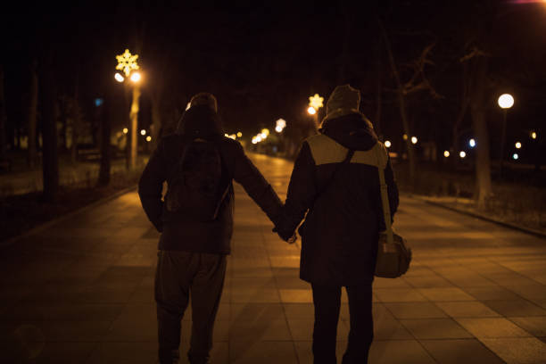 istock Homosexual couple in night walk 907890436