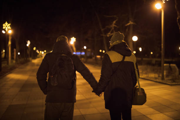 istock Homosexual couple in night walk 907890636