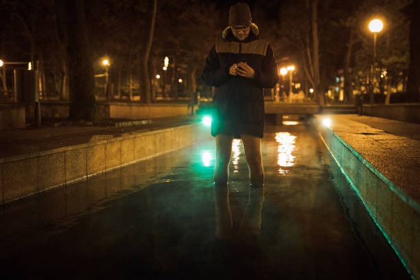 istock Man having natural footbath in thermal pool at night 907891656