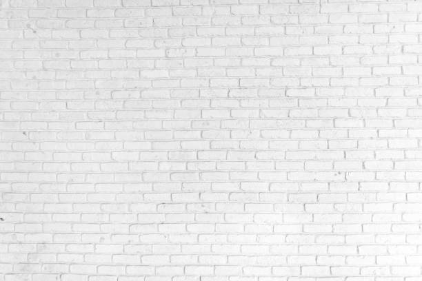 ホワイトのレンガの壁を背景に - レンガ ストックフォトと画像