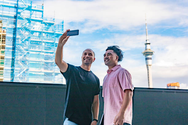 istock Pacific Islander Men Taking Selfies With Auckland Skytower 907896002