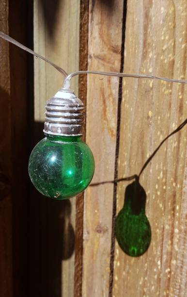 istock Multicolored string of party lights and shadow, hanging outside. 907899476