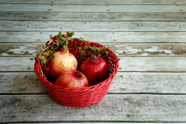 istock Autumn basket with pomegranates 907900150