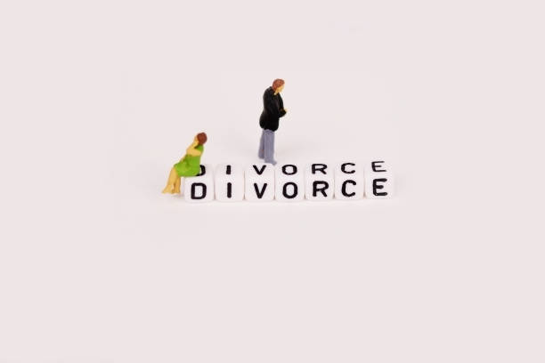 istock Divorce concept with young couple miniature close to separation 907903186