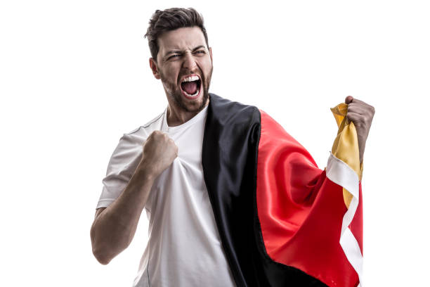 istock German male athlete / fan celebrating on white background 907906914