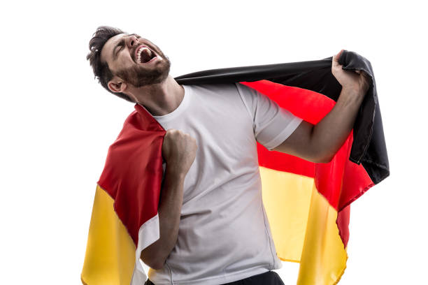 istock German male athlete / fan celebrating on white background 907906940
