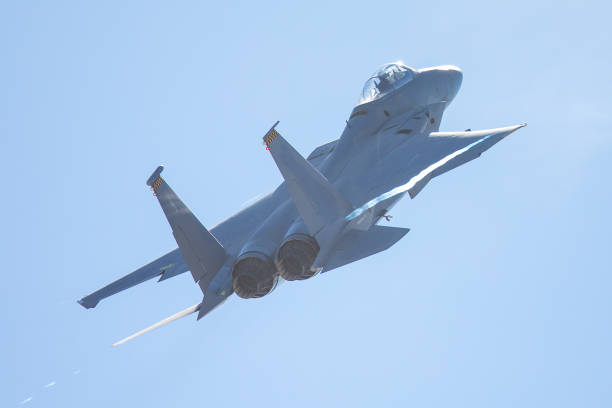 istock F-15 Eagle in a very close rear view, with condensation trails forming at the wing tip 907907576