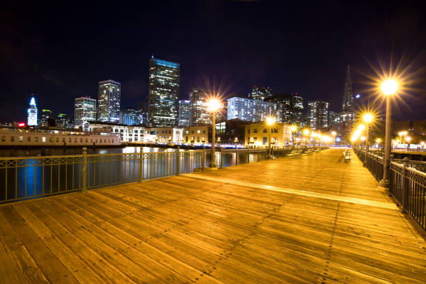 istock empty wood sidewalk near water in modern city 907910018